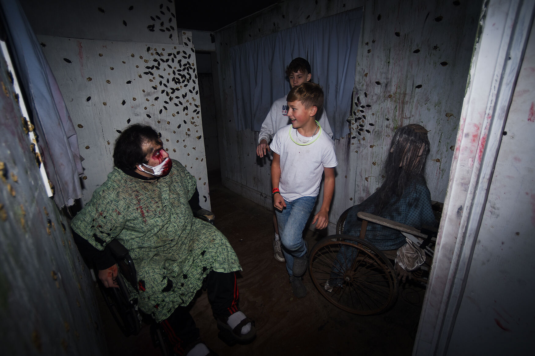 Halim Mavrakis jumps out at Vincent Gabriele, 14, who stands in front of James Fisher, 17, inside the asylum
